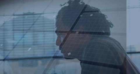 Leaning profile man studying data overlay with glass reflection in modern office