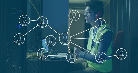 Network Engineer Configuring System in Server Room with Headphones