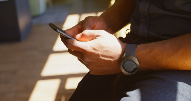 Man Using Smartphone in Sunlit Room - Download Free Stock Images Pikwizard.com