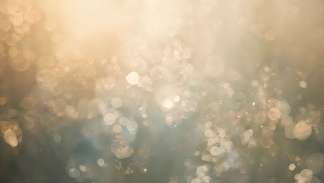 Glittering golden and cool blue bokeh abstract with dew highlights and sunlit sparkle