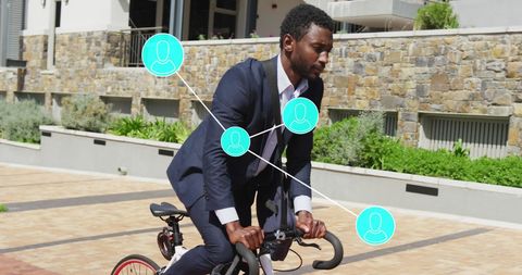 Businessman in Suit Riding Bicycle with Digital Connectivity