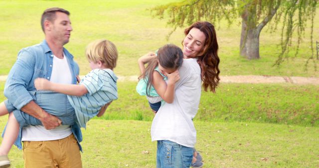 Happy Young Family Playing with Children in Park on Sunny Day - Download Free Stock Images Pikwizard.com