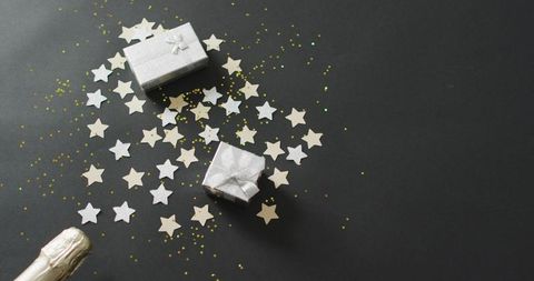 Festive presents and star confetti for new year's eve celebration