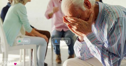 Senior man covering face in group therapy circle with social media engagement overlays