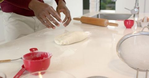 African American Man Kneading Dough on Bright Modern Kitchen Countertop Home Baking Scene