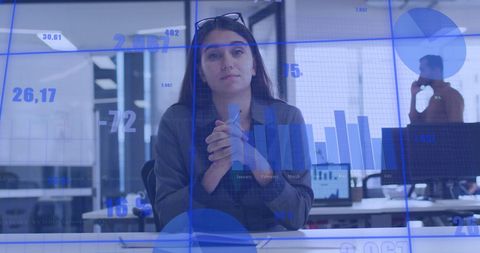 Businesswoman Analyzing Data in Modern Office with Interface Overlay