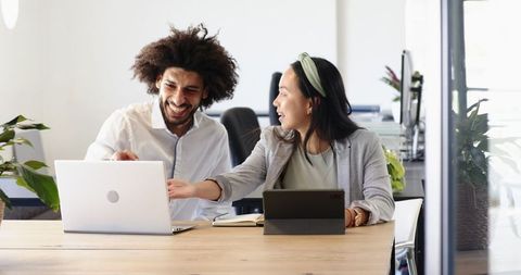 Multicultural colleagues collaborating in modern office