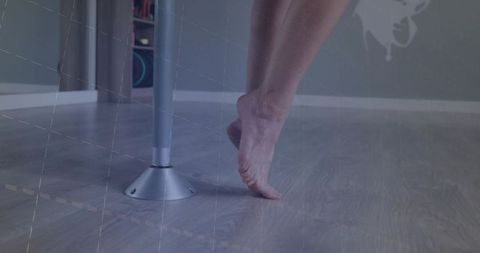 Ballet dancer on pointe at pole fitness studio
