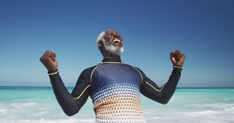 Senior Man Relishing Ocean Breeze on Sunny Day at Beach