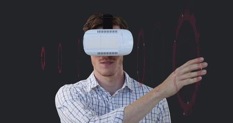 Man Wearing VR Headset Interacting with Holographic Red Interface Rings for Tech Marketing and UX
