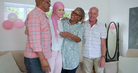 Senior Friends Hugging and Celebrating Joyful Reunion at Home