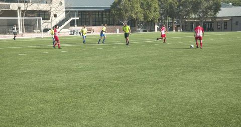 Soccer Teams Prepare for Kickoff on a Sunny School Field