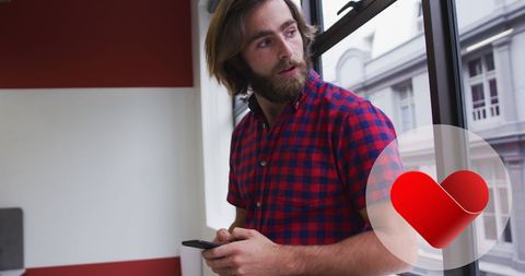 Young Professional with Smartphone and Modern Heart Icon Concept