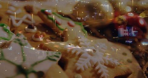 Double-exposure decorated christmas cookies with snowflake icing and city night lights