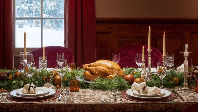 Elegant festive dining table with plush turkey and holiday decor