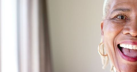 Smiling Senior African American Woman Embracing Joyful Moment