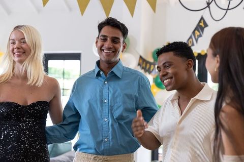 Diverse group of friends celebrating in stylish interior