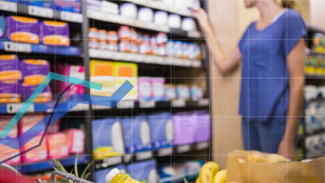 A young woman in a blue shirt stands holding a trolley, shopping in a supermarket. In front of her, graph lines and grids indicative of data processing appear, overlaying the video. The shopping isle is stocked with various grocery products, including packaged goods and fresh fruits. Perfect for illustrating modern retail, shopping habits, data analysis in commerce, and business technology innovation.