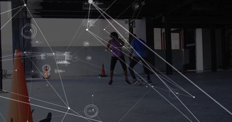 Adults dribbling soccer ball in industrial space with ar hud and training cones