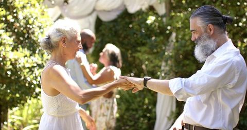 Elderly Couple Dancing at Joyful Outdoor Wedding Celebration
