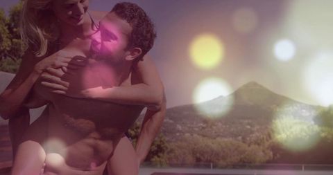 Romantic Couple Enjoying Vacation at Sunset with Swimming Pool