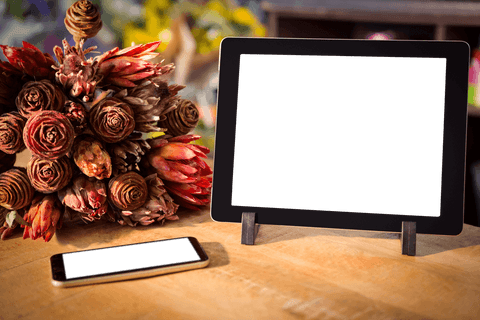 tablet mockup with transparent screen and floral arrangement on wooden table - Download Free Stock Videos Pikwizard.com