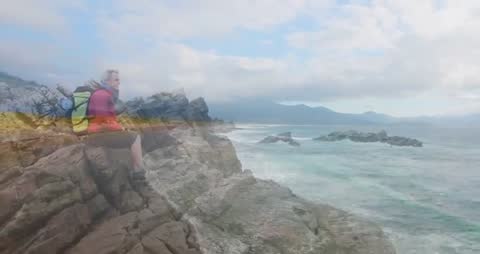 Hiker Reflecting by Ocean with Marketing Charts