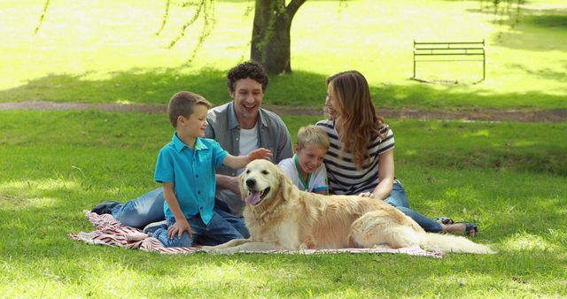 Family enjoying day outdoors sitting on lawn with pet dog. Perfect for advertisements promoting family activities, outdoor leisure, animal companionship, and summer fun. Ideal for use in websites, blogs, and magazines focused on family life, parenting tips, and pet care.