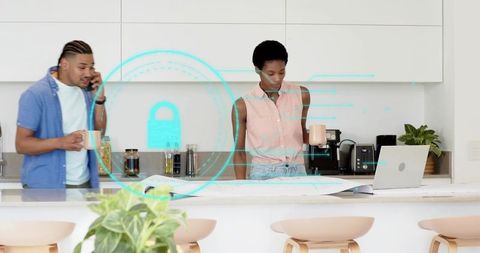 Couple collaborating on blueprint at modern kitchen island with digital security overlay