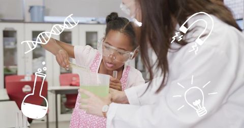 Young girl conducting colorful chemistry experiment while teacher guides in classroom lab