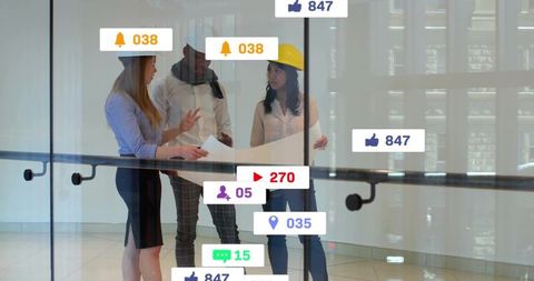 Architects reviewing blueprint with augmented reality notifications floating on glass
