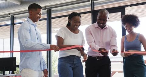 Team Celebrating Ribbon Cutting at Office Event
