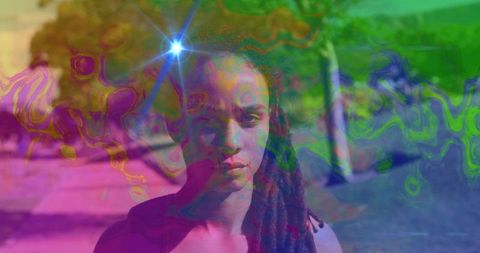Young woman with dreadlocks portrait overlaid with psychedelic color swirls and lens flare