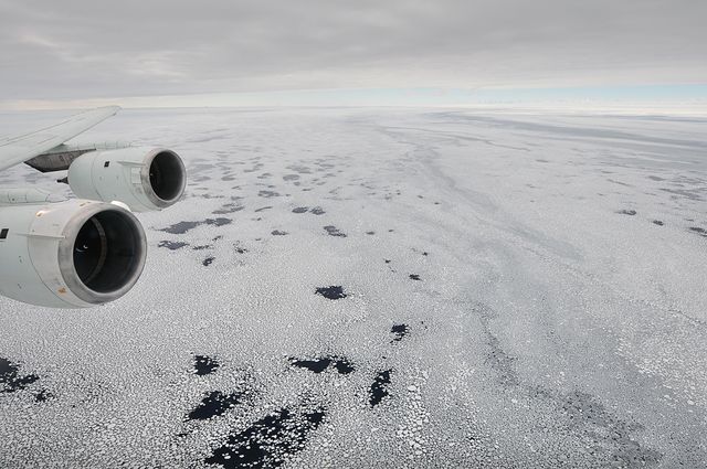 Aerial view from NASA's DC-8 aircraft flying 2,000 feet above the Bellingshausen Sea in West Antarctica. Operation Ice Bridge focuses on studying Antarctic ice sheets and sea ice. Great for illustrating climate research, aviation technology, and polar exploration studies.