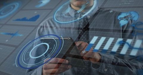 Businessman Holding Tablet Interacting with Futuristic Holographic Data Dashboard