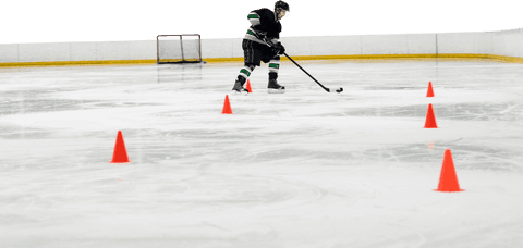 Caucasian male hockey player practicing drills on transparent ice rink