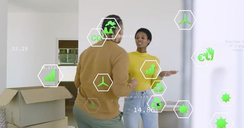 Young couple unpacking boxes in modern home with eco metrics overlays for sustainable living