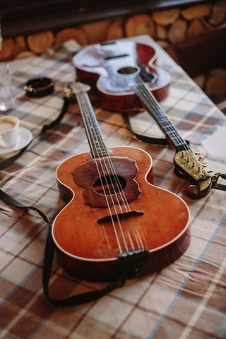 Vintage acoustic guitars on checkered tablecloth for music enthusiasts