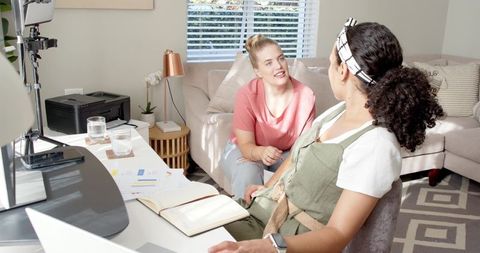 Diverse female colleagues collaborating in home office setting