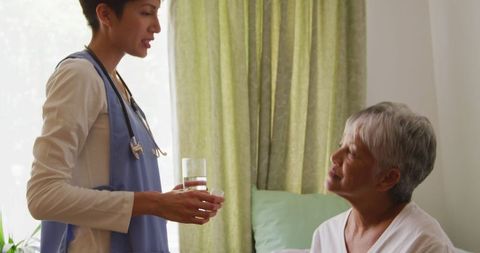 Doctor Caring for Senior Woman in Retirement Home