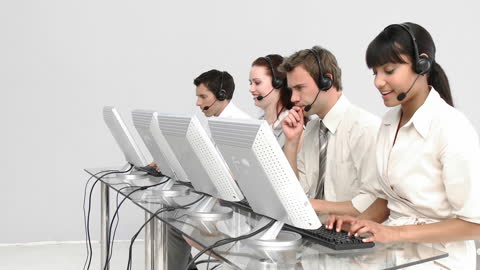 Team of Call Center Agents Working in a Modern Office Environment