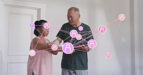 Senior couple exploring tablet with pink social network overlay for digital connectivity