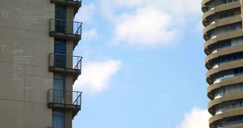Contrasting high-rise facades with balcony railings and curved tower against blue sky