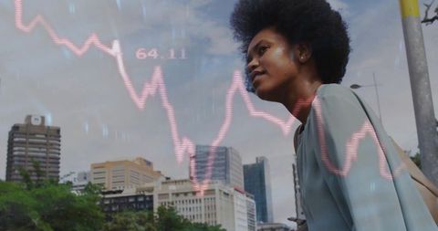 Confident professional analyzing financial trends in urban environment