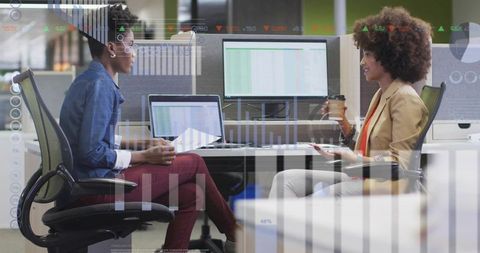 Professional Women Analyzing Data and Discussing Strategies