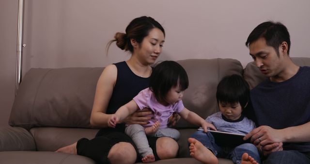 Young Family Bonding on Sofa Using Digital Tablet Indoors - Download Free Stock Images Pikwizard.com