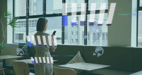 Asian woman holding smartphone in office lounge interacting with holographic interface