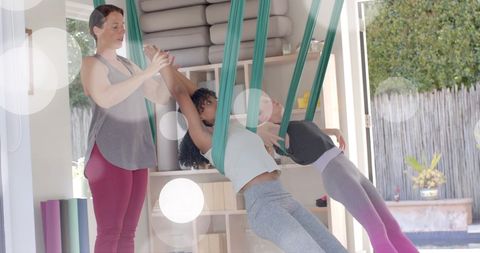 Diverse Teens Enjoying Aerial Yoga at Home for Wellbeing and Fun