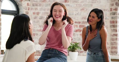 Women Celebrating Engagement in Modern Kitchen Setting