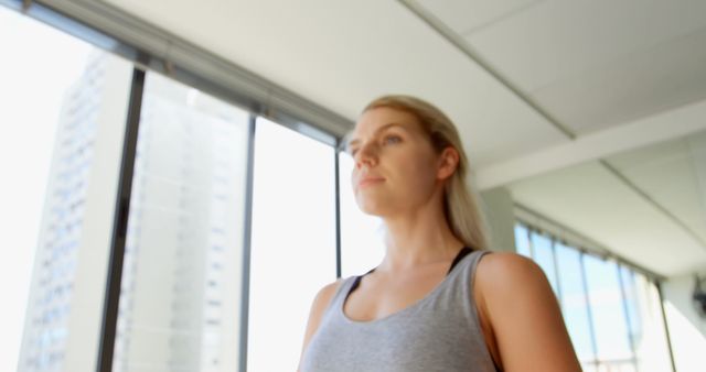 Focused Woman Exercising on Treadmill in Gym with City View - Download Free Stock Images Pikwizard.com